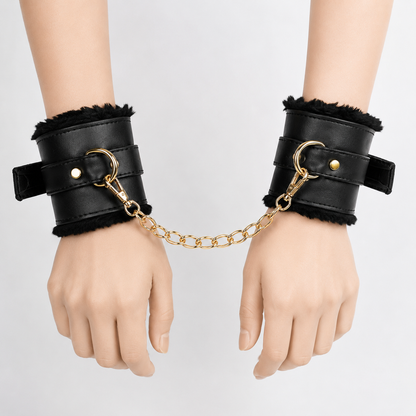 Premium adjustable wrist cuffs with black faux leather exterior and gold chain connector.